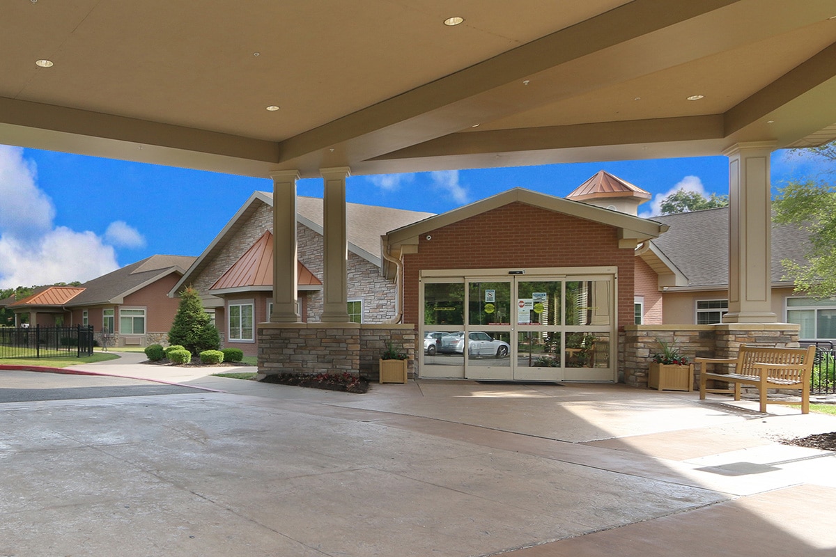 Outside entrance to facility with large doors and covered entrance