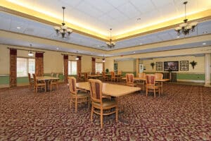 Large dining room with floral carpet and chandeliers