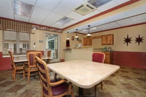 Dining room with four top tables and kitchenette