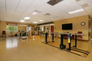 Rehab gym with parallel bars and bike equipment