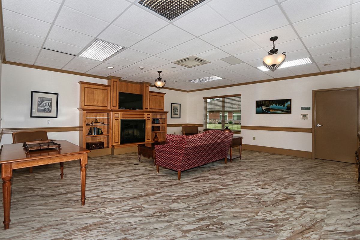 Larger view of lobby with sofa, fireplace and flat screen TV