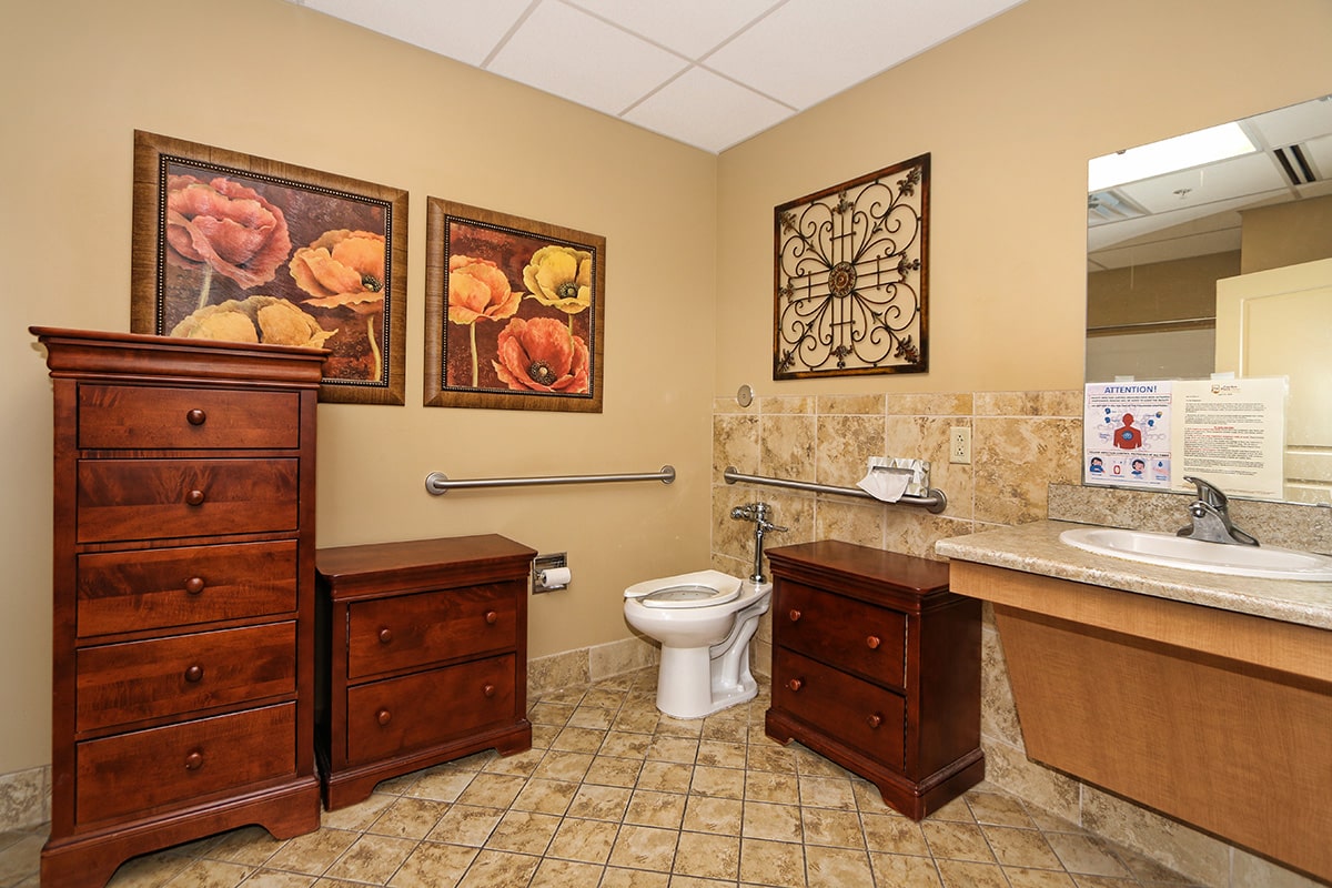 Bathroom with floral paintings on the wall
