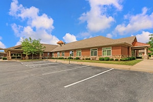 Front of facility with covered driveway to entrance